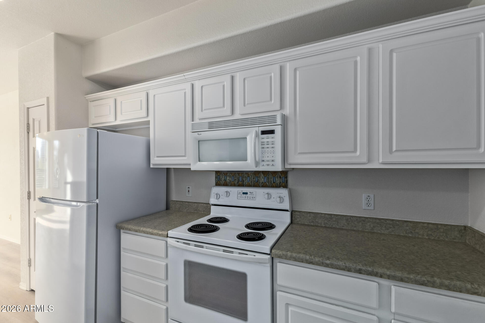 435 West Rio Salado Parkway, Unit 210 Tempe, AZ 85281 - Photo 12 of 35 a kitchen with white cabinets and white appliances