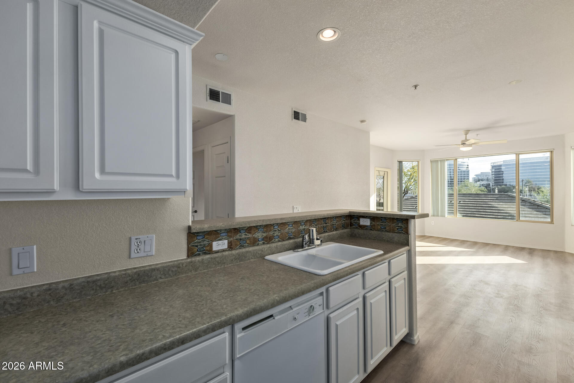 435 West Rio Salado Parkway, Unit 210 Tempe, AZ 85281 - Photo 10 of 35 a kitchen with granite countertop a sink and white cabinets