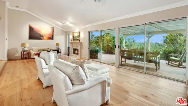 a kitchen with stainless steel appliances kitchen island granite countertop a table chairs and a refrigerator