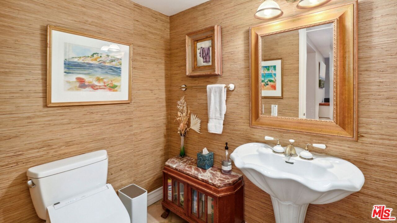 3548 Rosa Way Fallbrook, CA 92028 - Photo 25 of 49 a bathroom with a toilet a sink and mirror