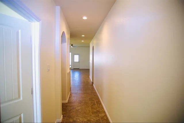 a view of hallway with wooden floor