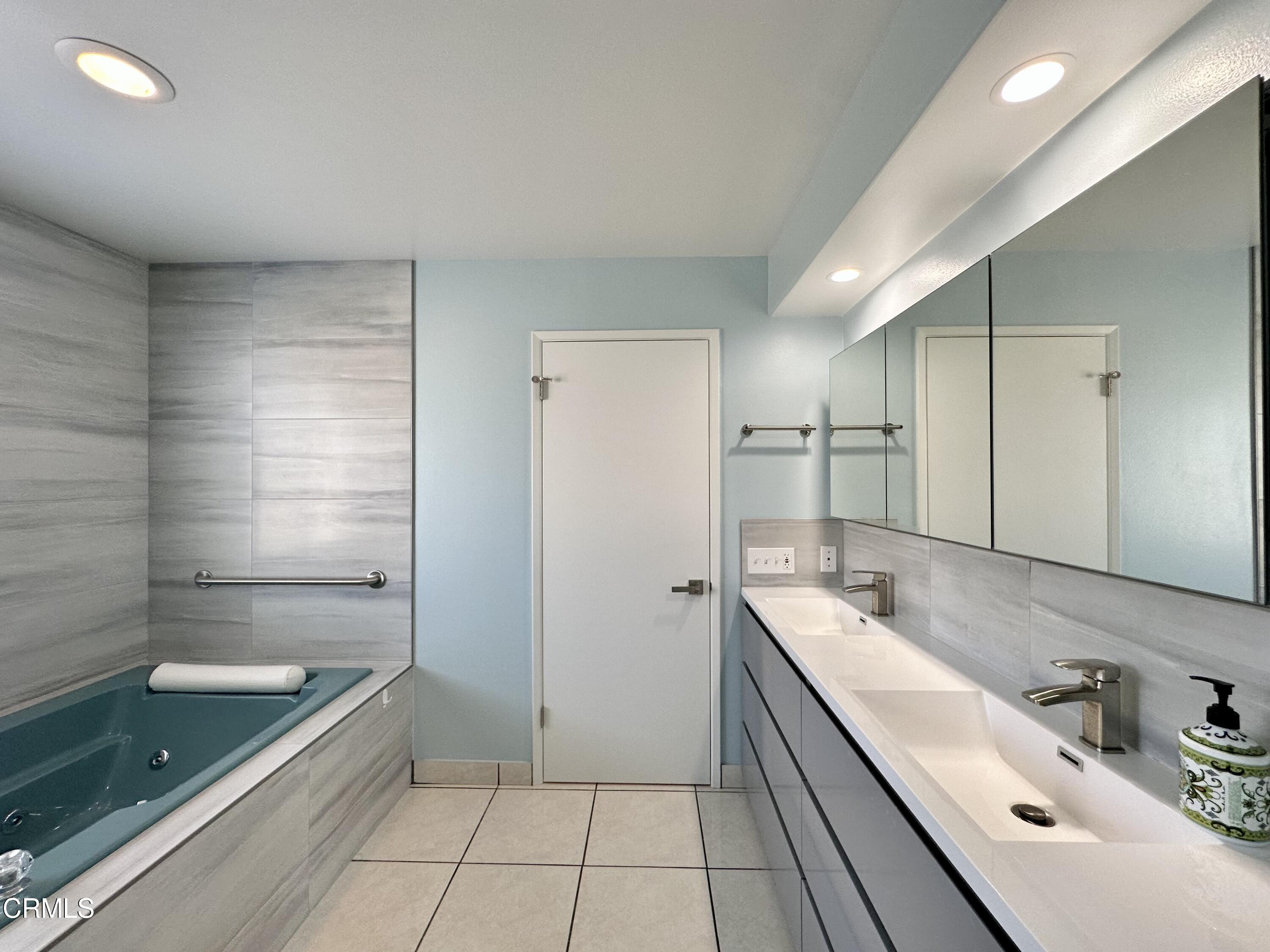 4053 Sunset Lane Oxnard, CA 93035 - Photo 20 of 33 a bathroom with a granite countertop sink a bathtub and shower