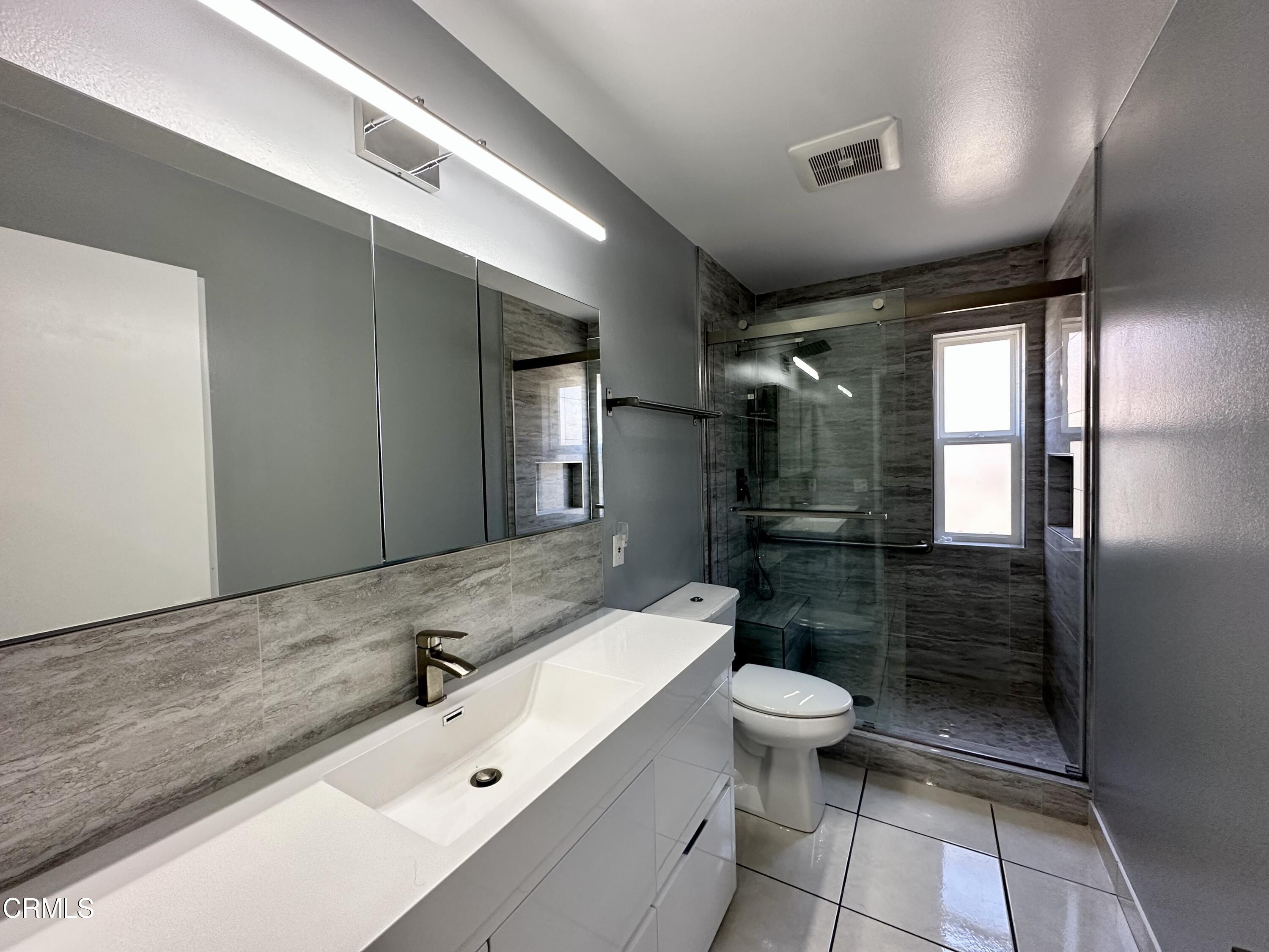 4053 Sunset Lane Oxnard, CA 93035 - Photo 27 of 33 a bathroom with a sink a toilet a mirror and shower