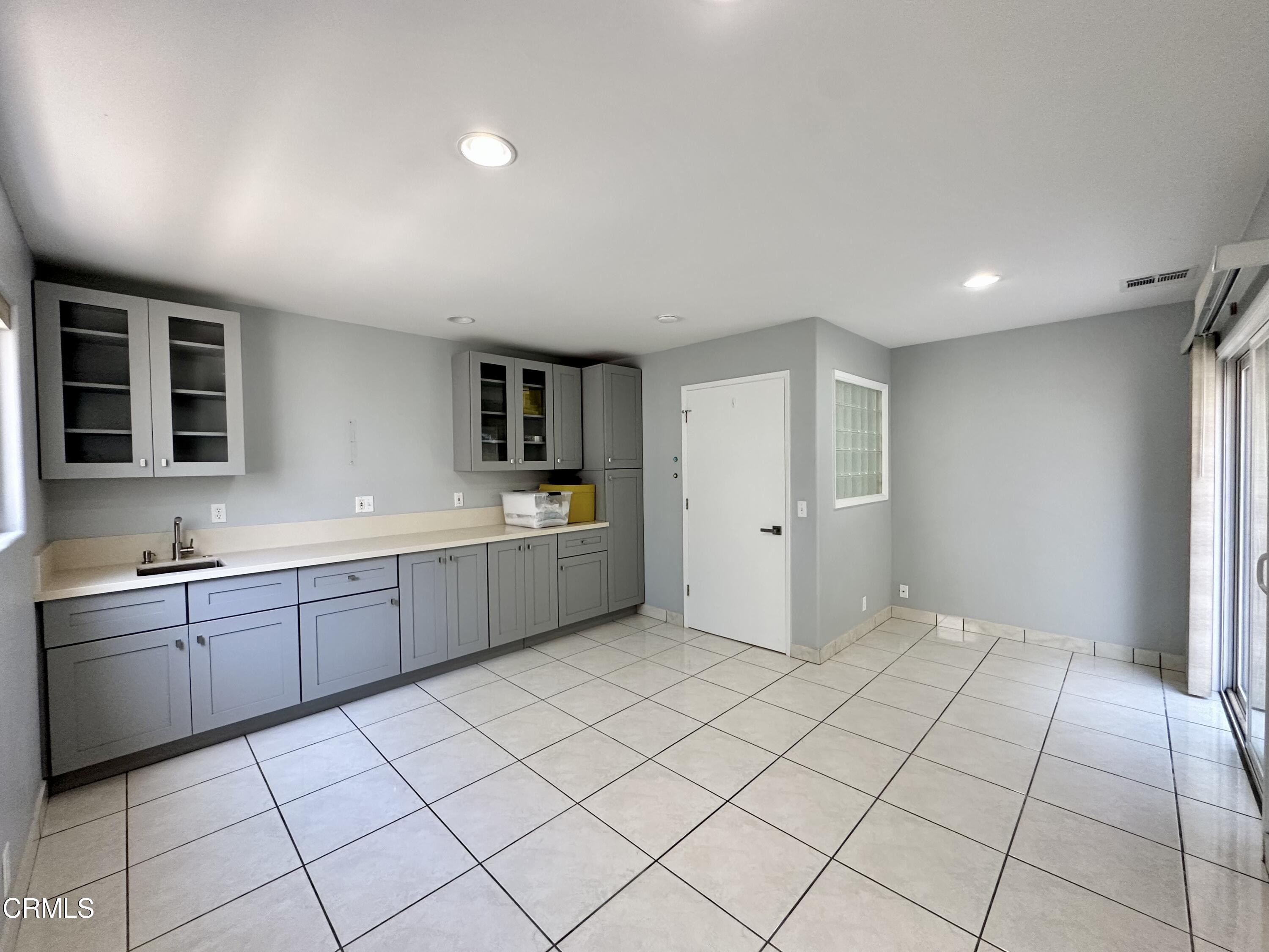 4053 Sunset Lane Oxnard, CA 93035 - Photo 29 of 33 a large white kitchen with a sink