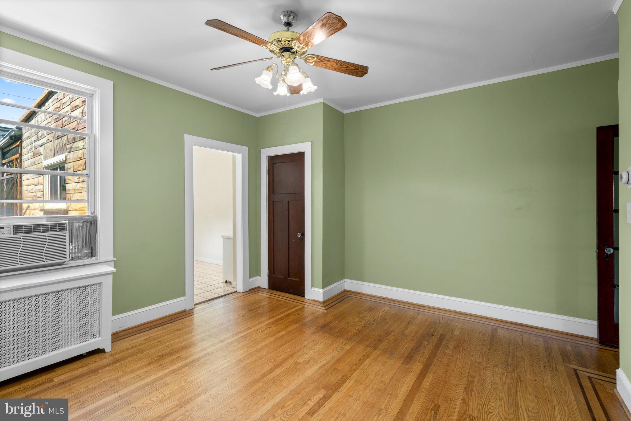 310 Drew Street Baltimore, MD 21224 - Photo 11 of 47 wooden floor in an empty room with a window