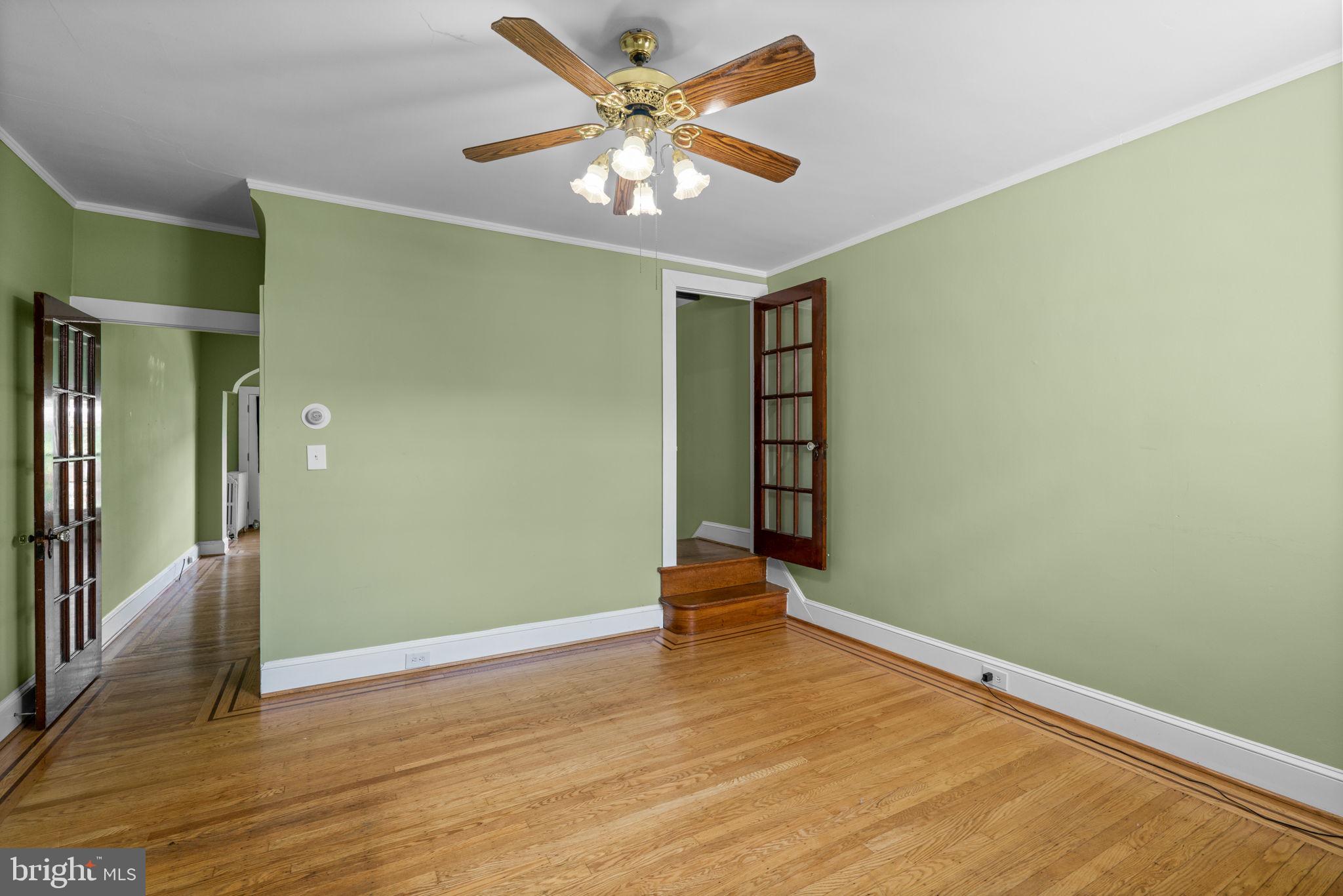 310 Drew Street Baltimore, MD 21224 - Photo 13 of 47 wooden floor in an empty room with a window