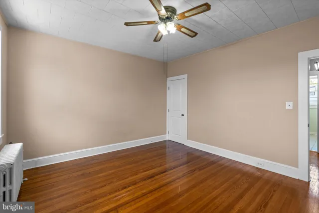 a view of room with wooden floor and window