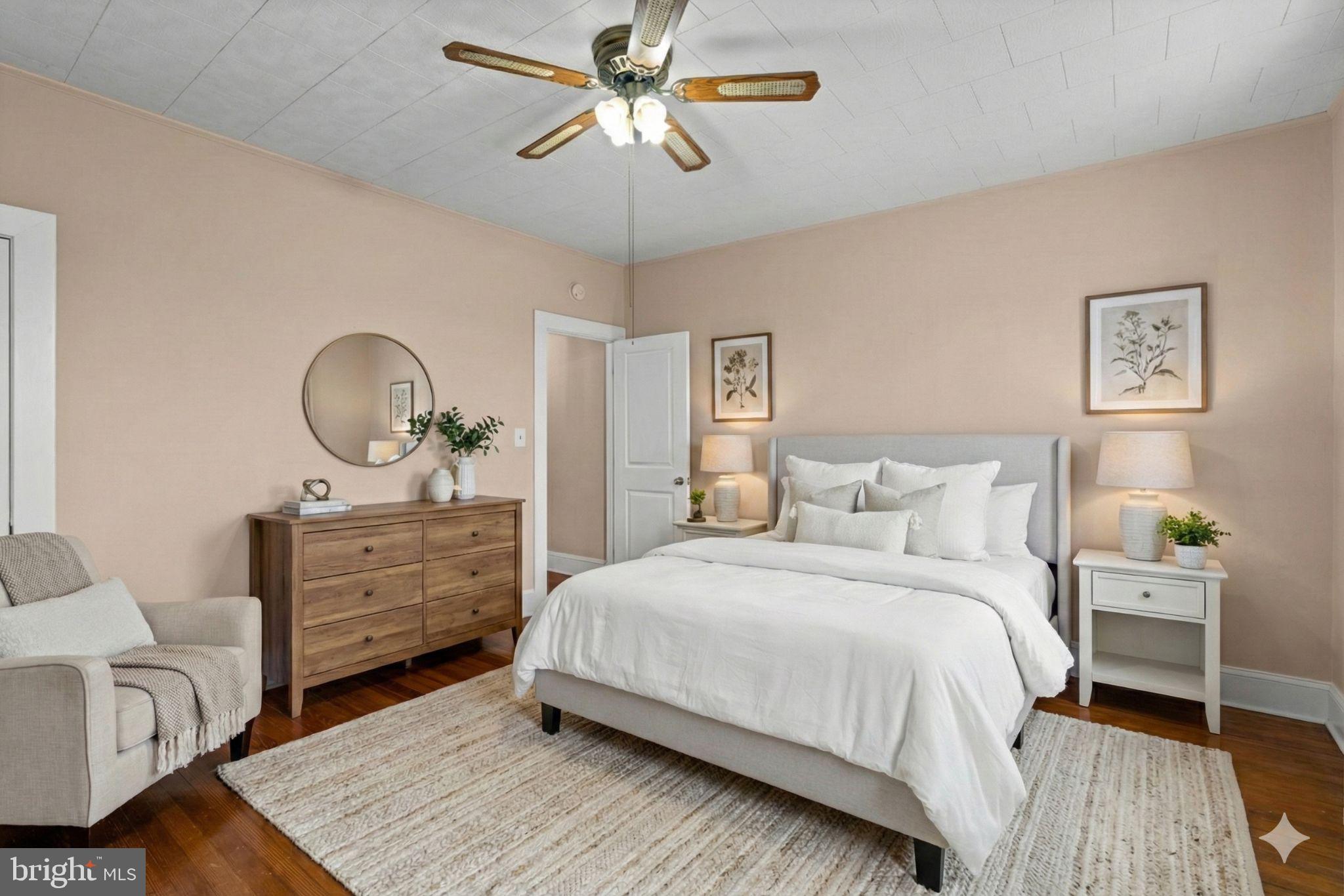 310 Drew Street Baltimore, MD 21224 - Photo 18 of 47 a bedroom with a bed and a chandelier