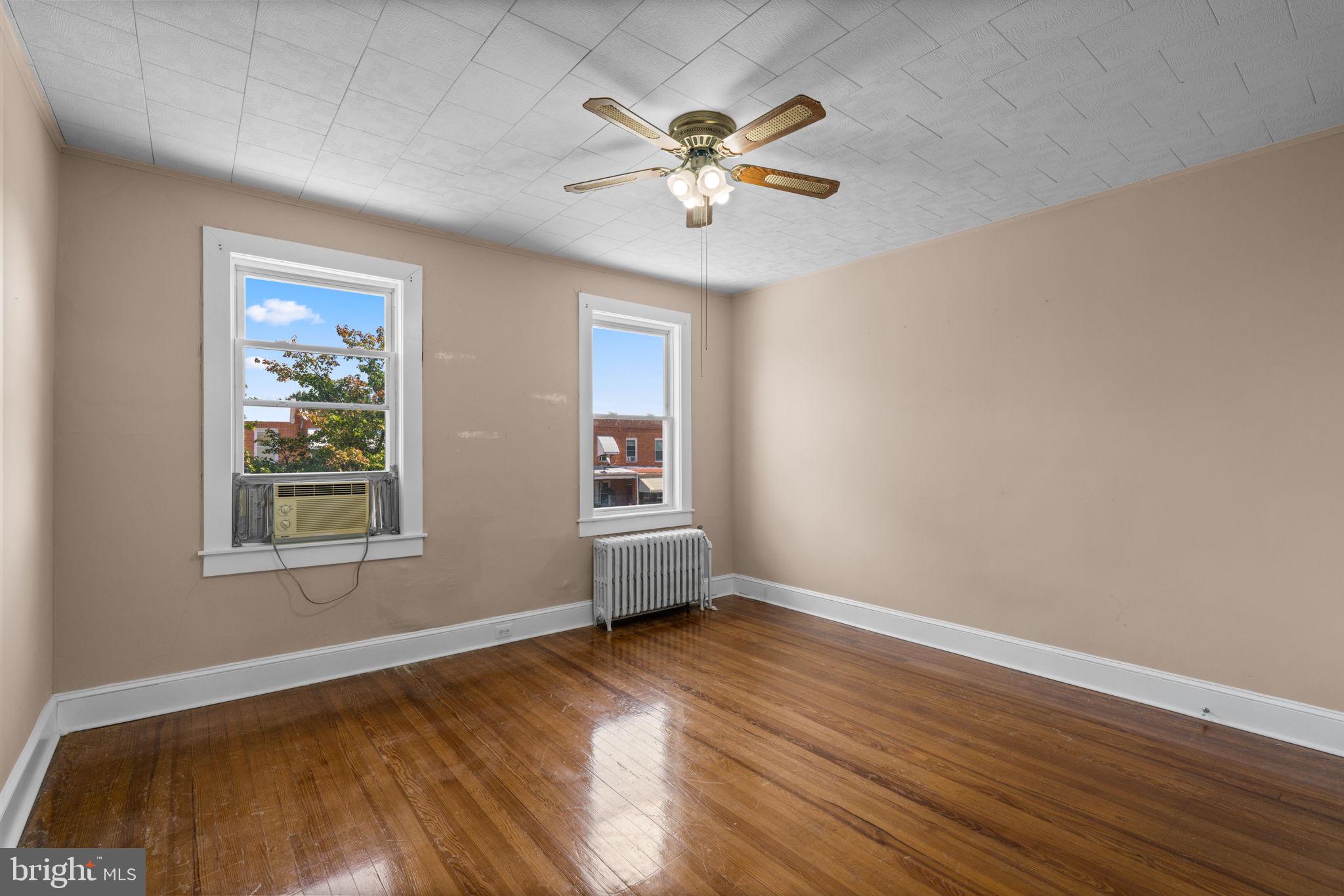 310 Drew Street Baltimore, MD 21224 - Photo 19 of 47 a view of an empty room with wooden floor and a window