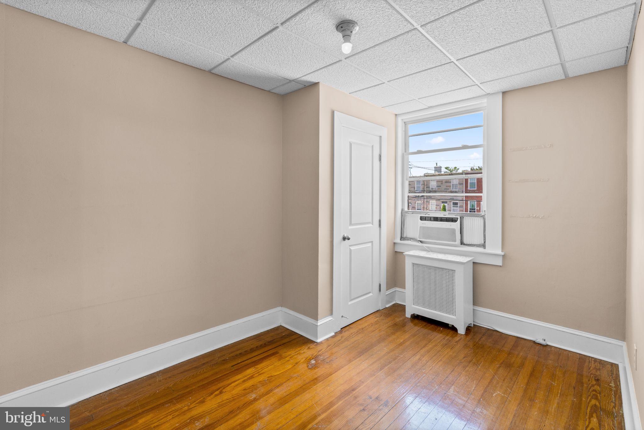310 Drew Street Baltimore, MD 21224 - Photo 22 of 47 a view of room with wooden floor and window