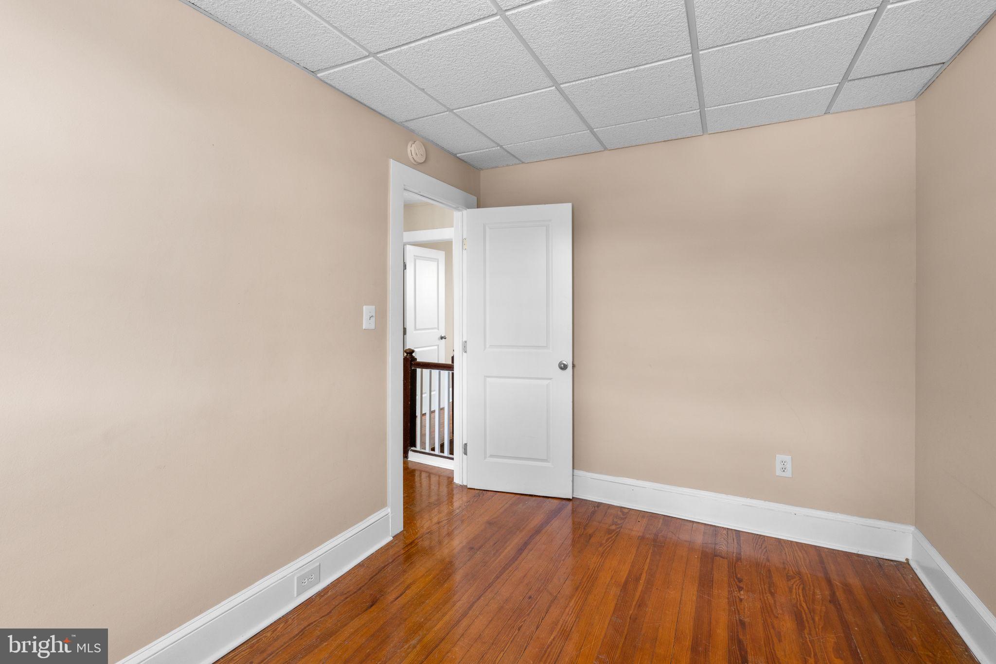 310 Drew Street Baltimore, MD 21224 - Photo 25 of 47 a view of an empty room with wooden floor