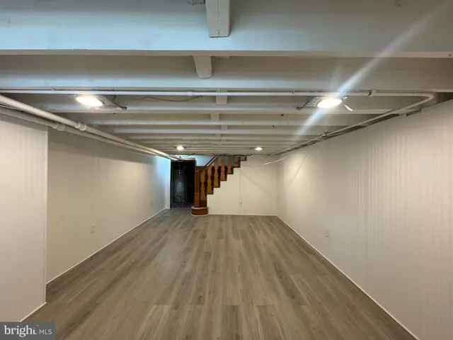 a view of a room with wooden floor