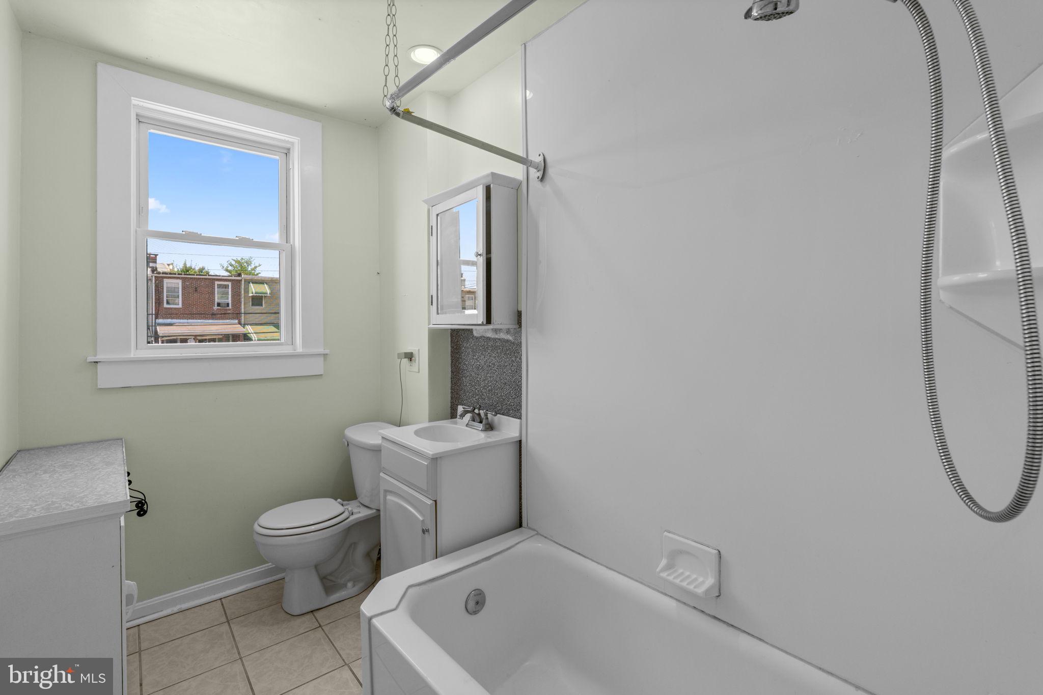 310 Drew Street Baltimore, MD 21224 - Photo 26 of 47 a bathroom with a toilet sink and shower