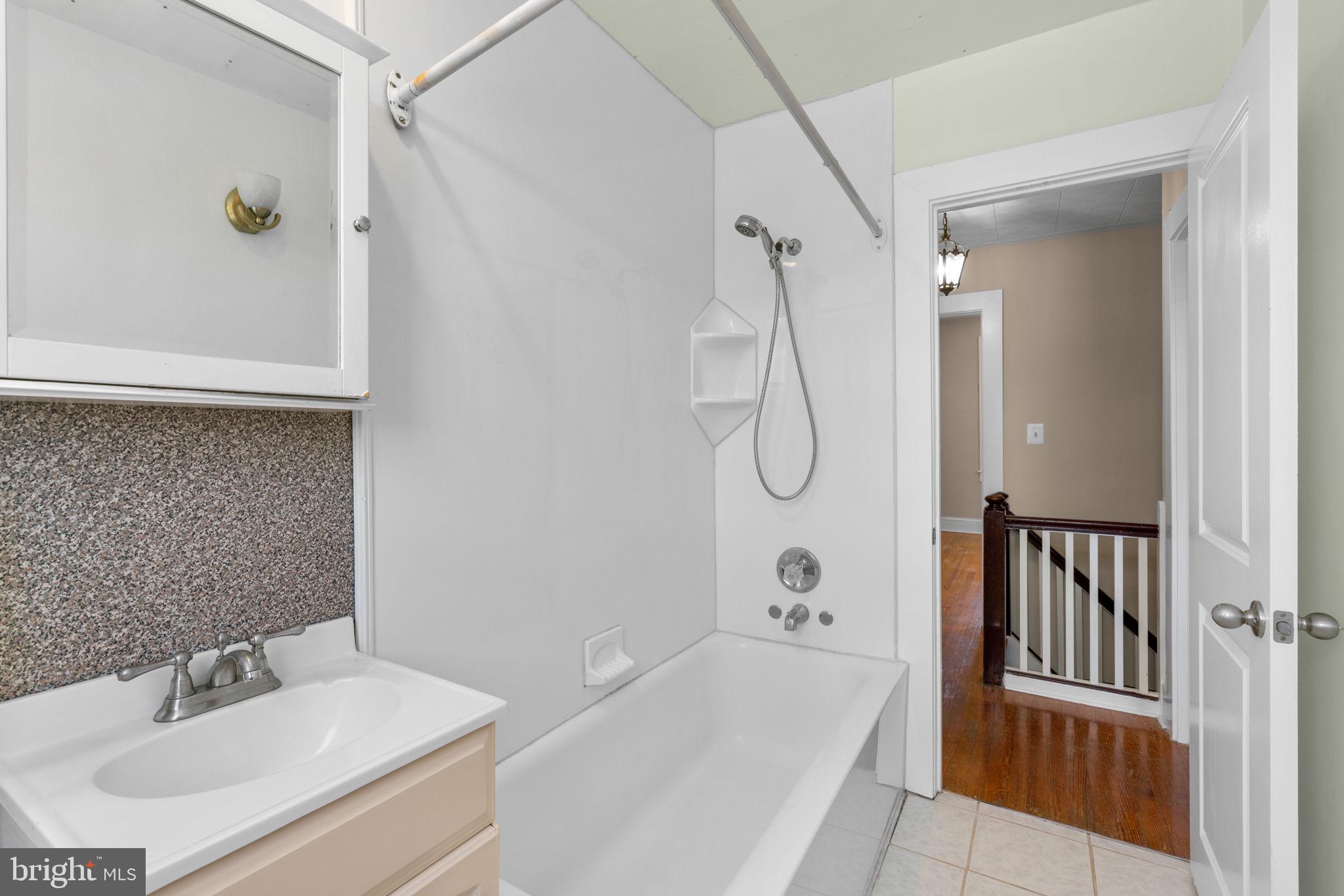 310 Drew Street Baltimore, MD 21224 - Photo 27 of 47 a bathroom with a sink a toilet and shower