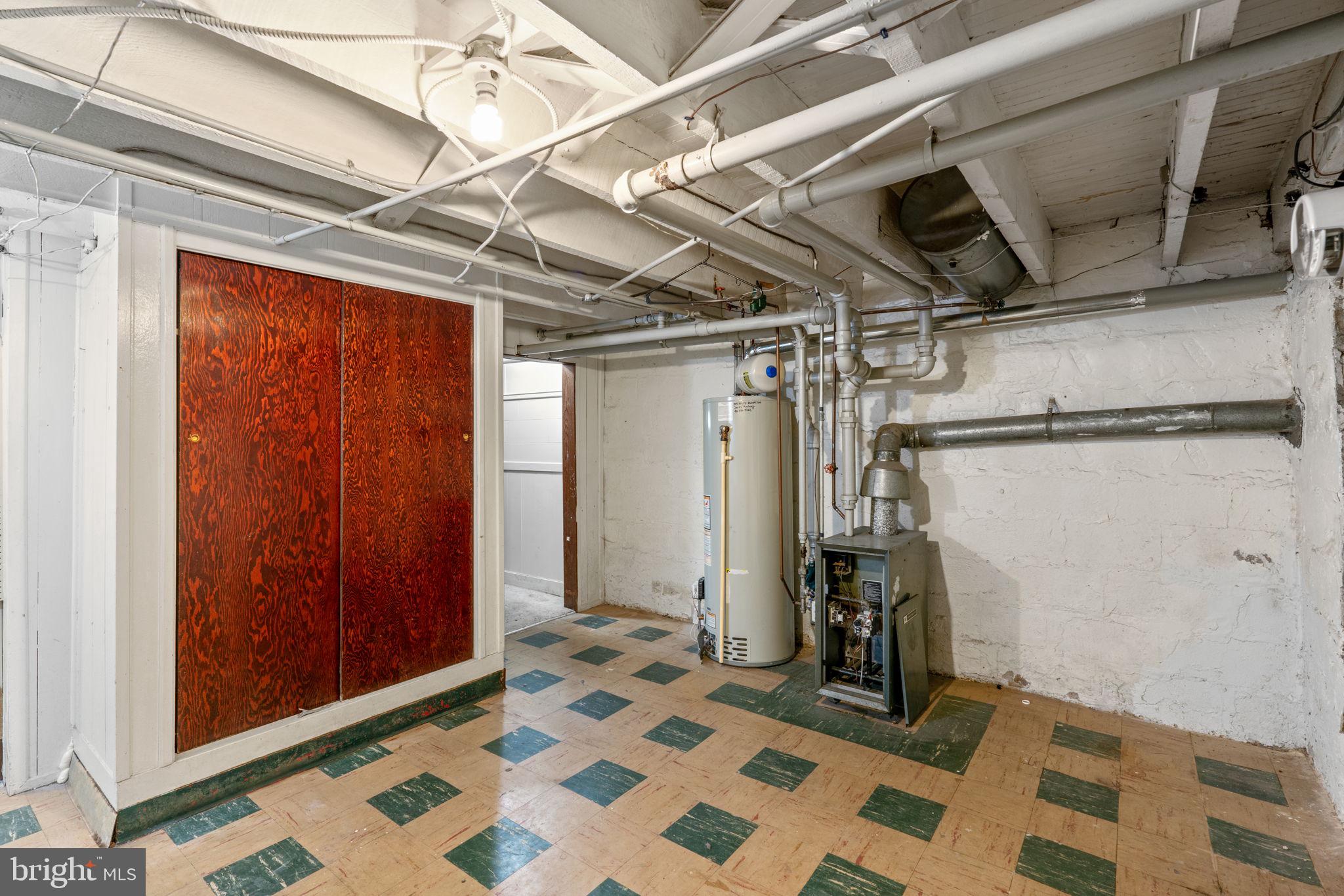 310 Drew Street Baltimore, MD 21224 - Photo 34 of 47 a view of walk in closet with clothes and shoes