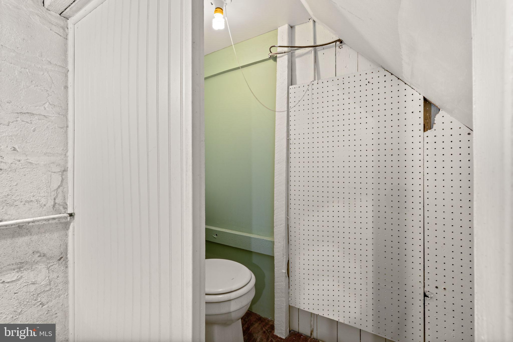 310 Drew Street Baltimore, MD 21224 - Photo 37 of 47 a bathroom with a toilet and a shower