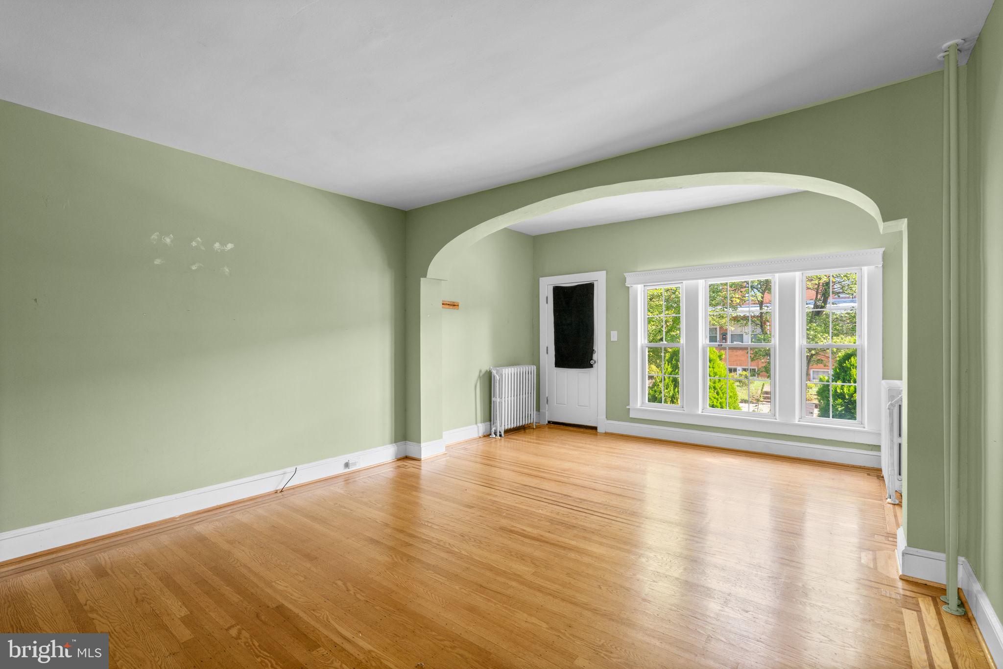 310 Drew Street Baltimore, MD 21224 - Photo 7 of 47 a view of a big room with wooden floor and windows
