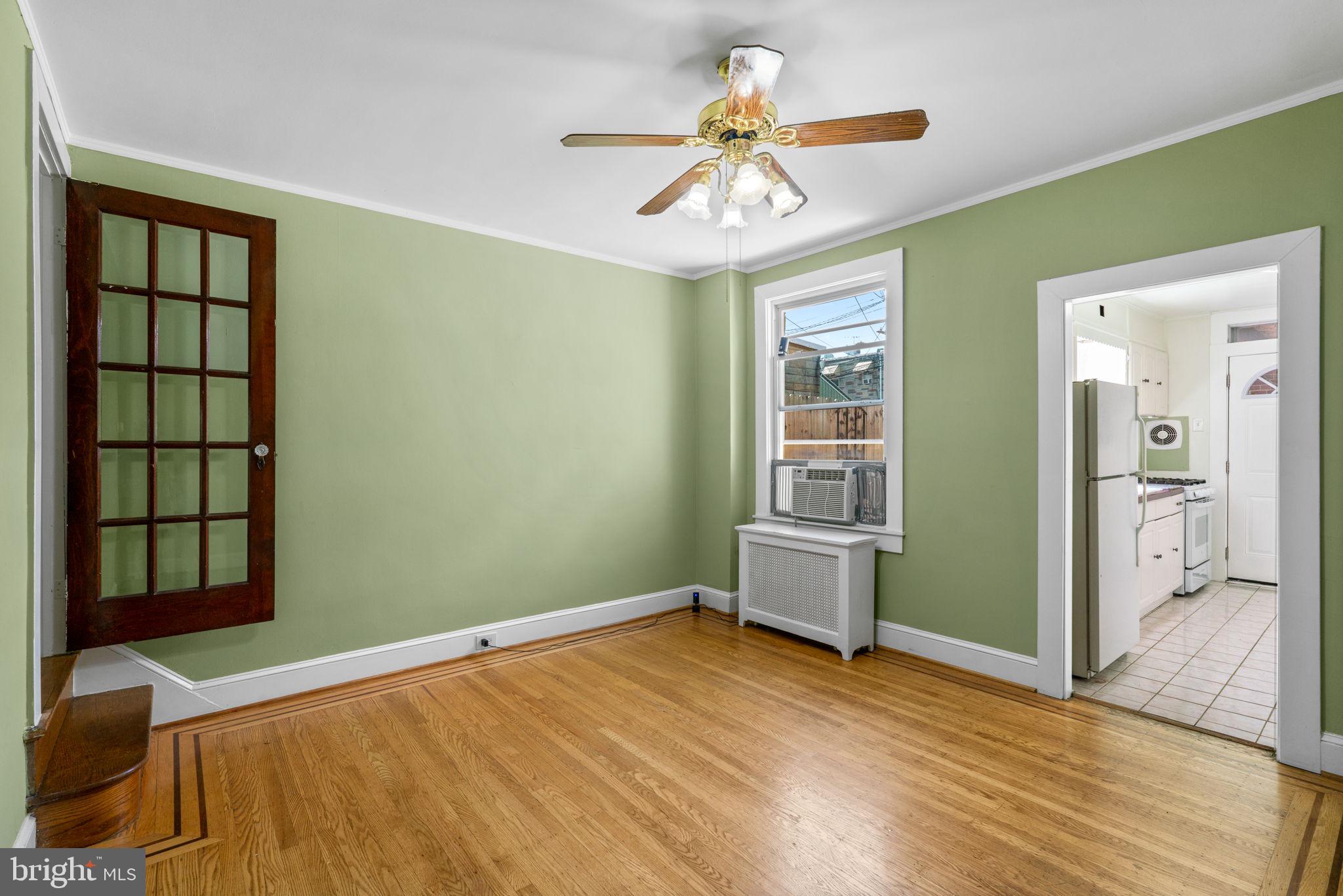 310 Drew Street Baltimore, MD 21224 - Photo 10 of 47 wooden floor in an empty room with a window