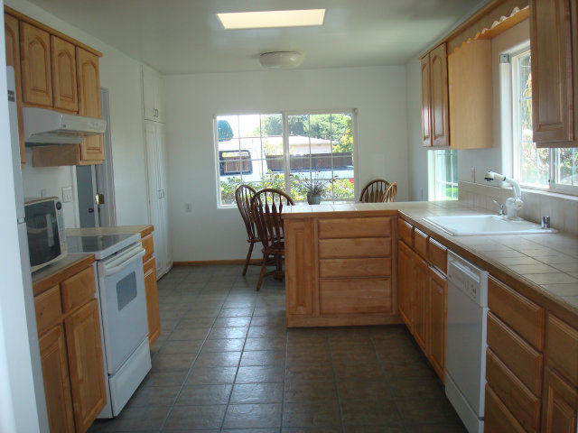 3401 Roland Drive Santa Cruz, CA 95062 - Photo 7 of 20 a kitchen with a stove a sink and a refrigerator