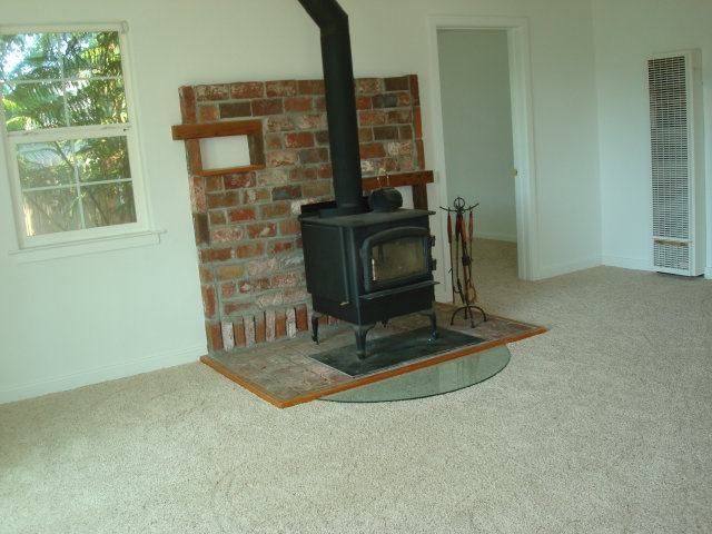 3401 Roland Drive Santa Cruz, CA 95062 - Photo 9 of 20 a living room with fireplace furniture and a window