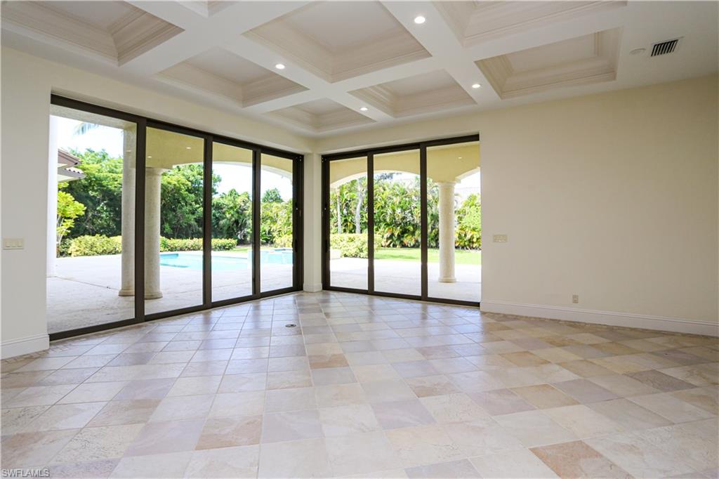 823 Cassena Road Naples, FL 34108 - Photo 37 of 50 a view of an empty room with a large window