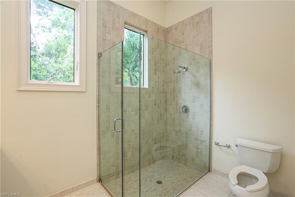 823 Cassena Road Naples, FL 34108 - Photo 39 of 50 a bathroom with a shower a toilet and a sink