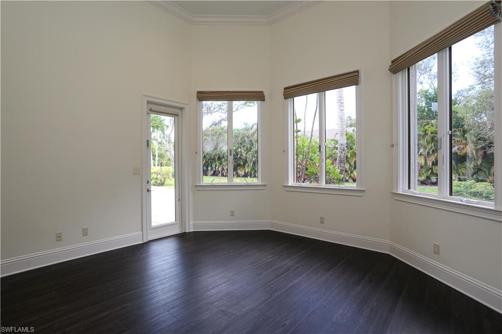 823 Cassena Road Naples, FL 34108 - Photo 40 of 50 a view of an empty room with wooden floor and a window