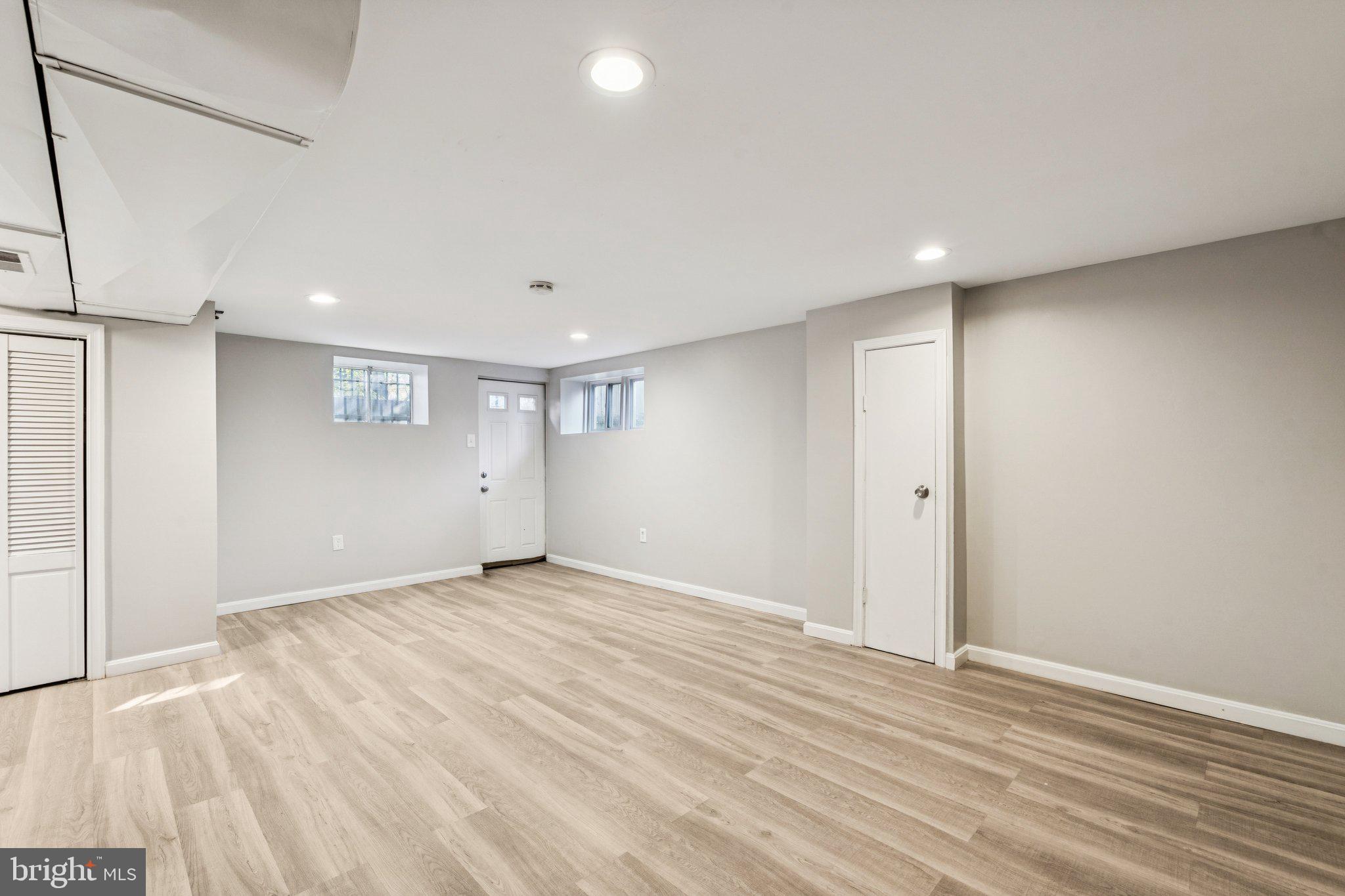 2803 Keating Street Temple Hills, MD 20748 - Photo 16 of 20 a view of an empty room with wooden floor and a window