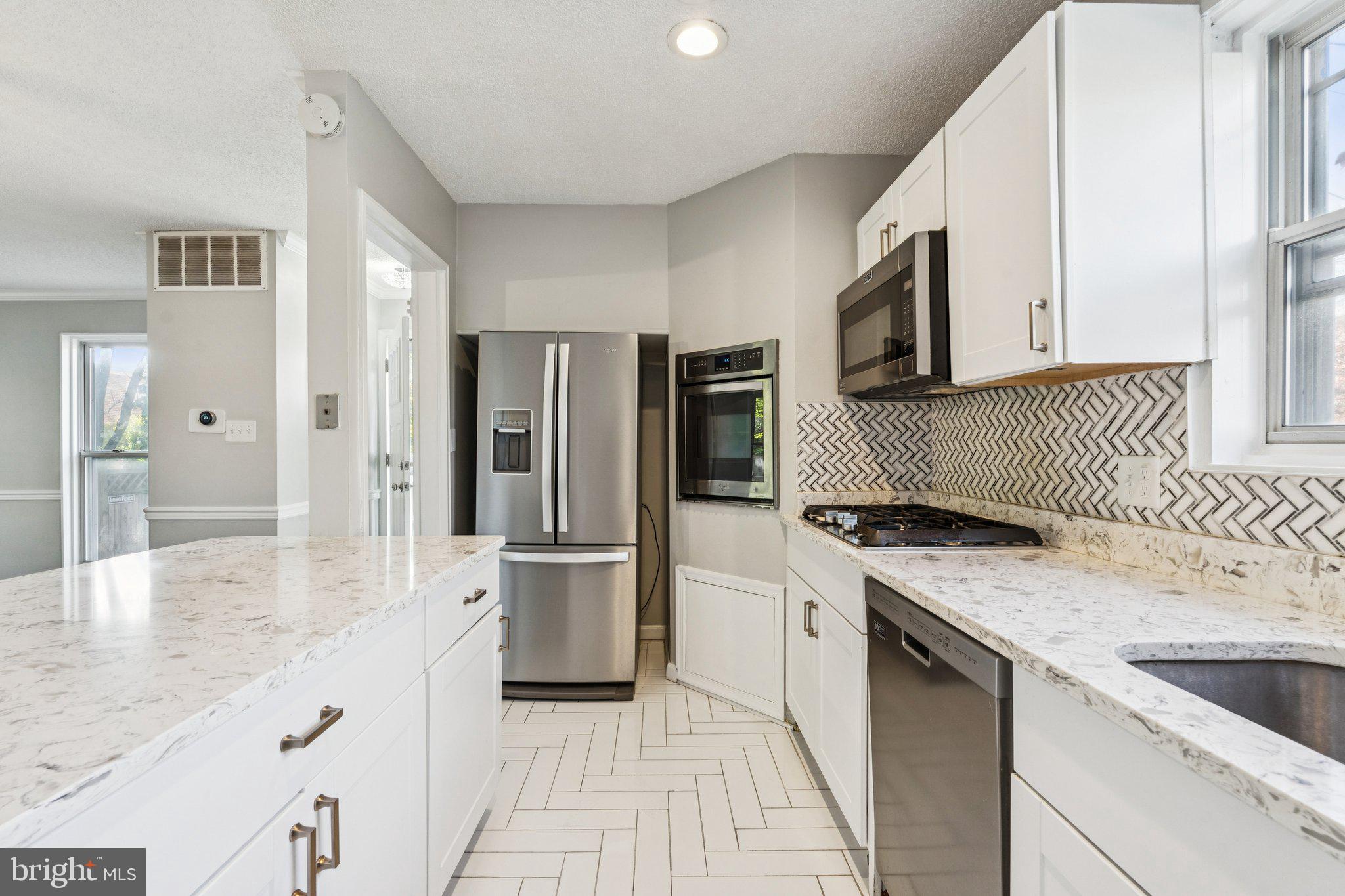 2803 Keating Street Temple Hills, MD 20748 - Photo 2 of 20 a kitchen with a sink stove and refrigerator