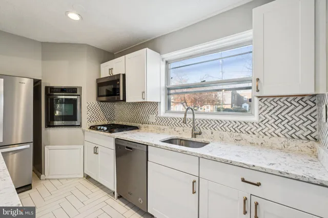 a kitchen with a sink stove and refrigerator