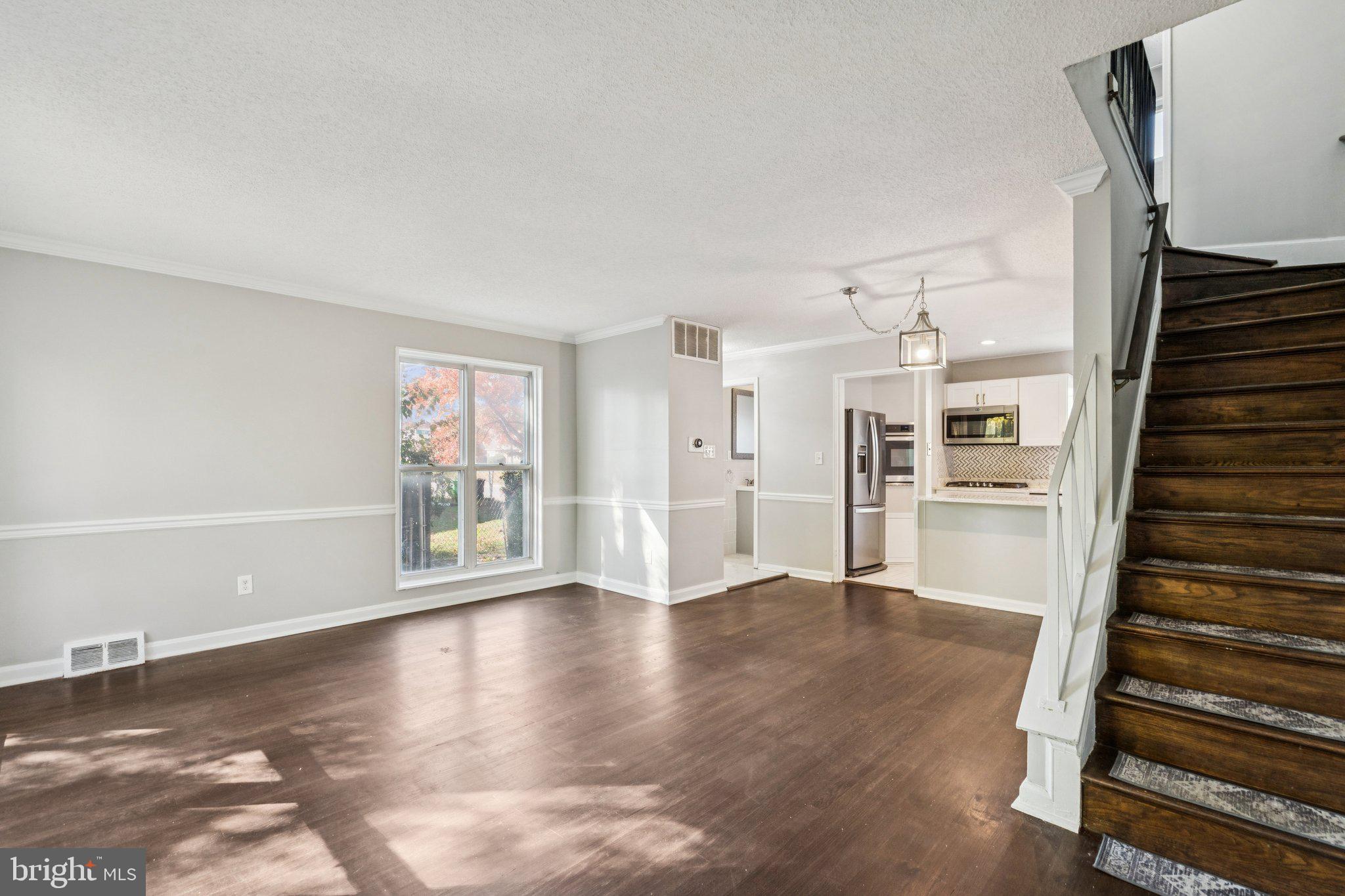 2803 Keating Street Temple Hills, MD 20748 - Photo 5 of 20 a view of a livingroom with wooden floor and stairs