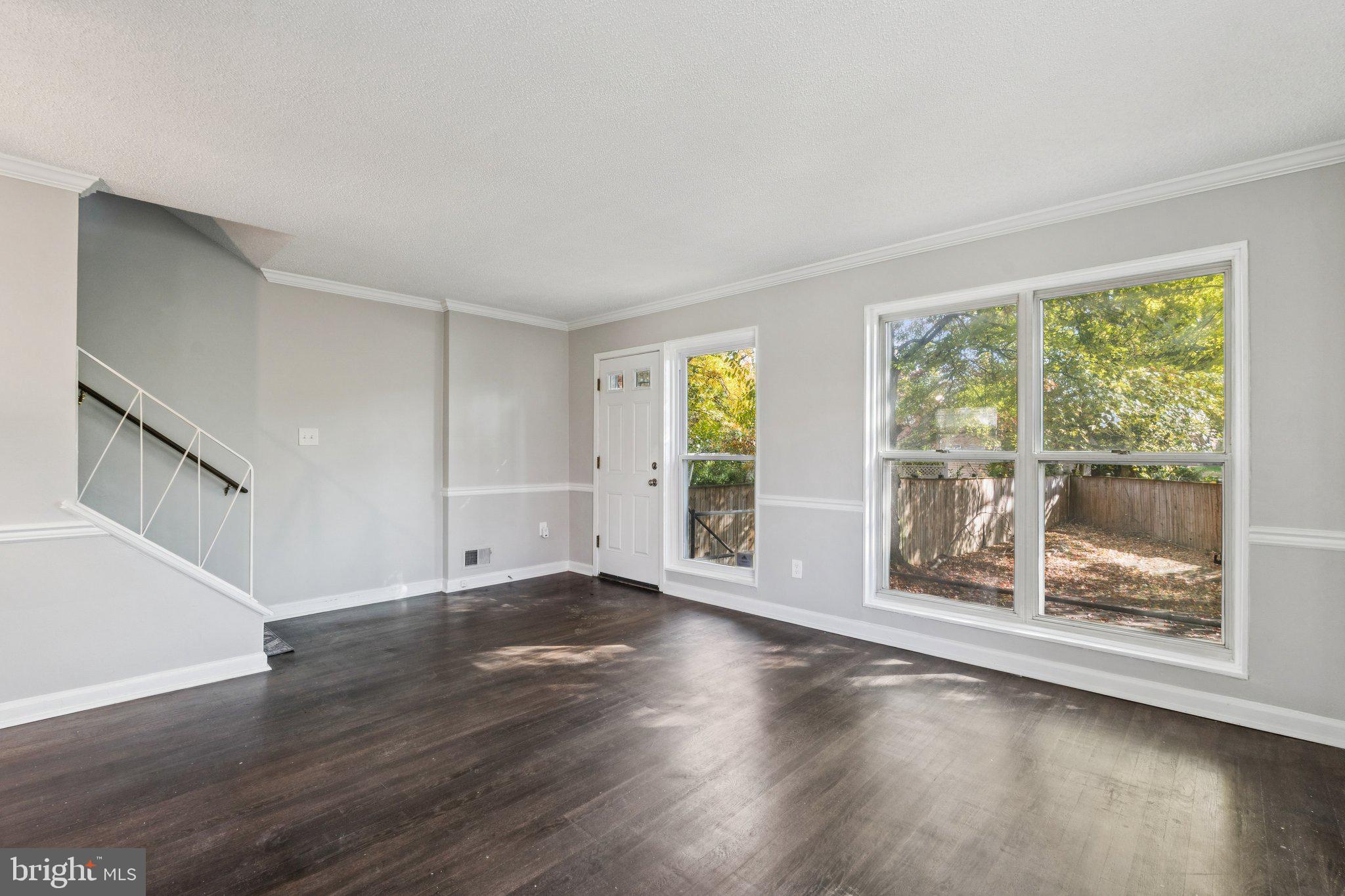 2803 Keating Street Temple Hills, MD 20748 - Photo 7 of 20 a view of an empty room with wooden floor and a window
