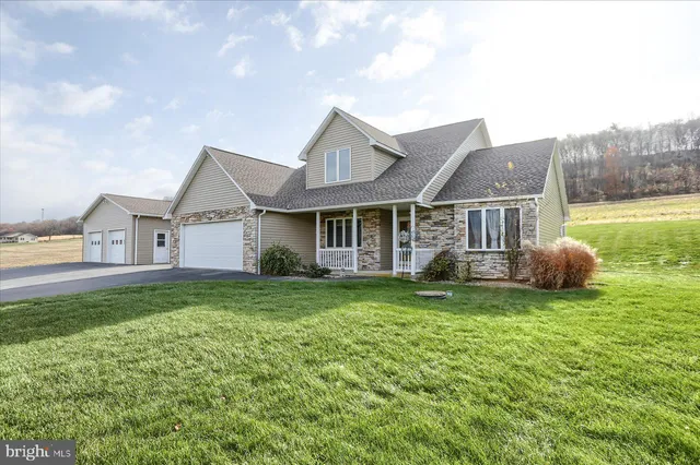 a view of a house with a yard and a porch