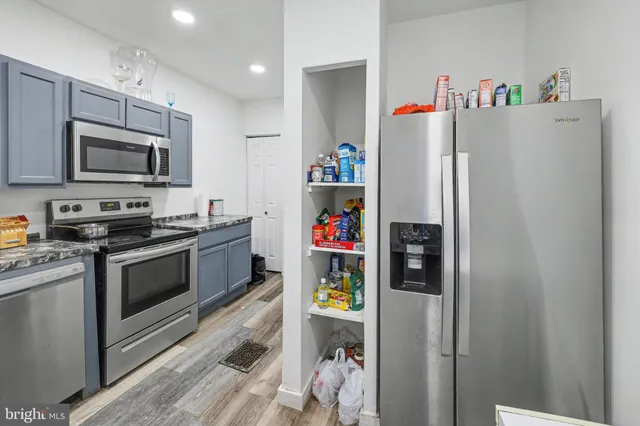 a kitchen with stainless steel appliances a refrigerator a stove and a microwave