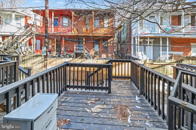 a view of a balcony with wooden chairs