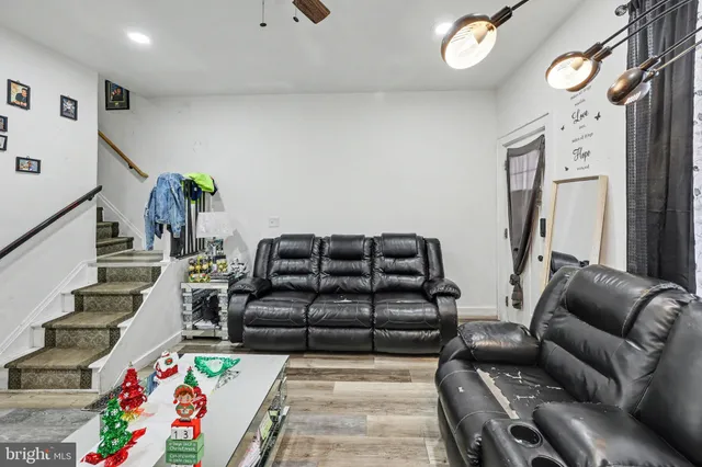 a living room with furniture and wooden floor