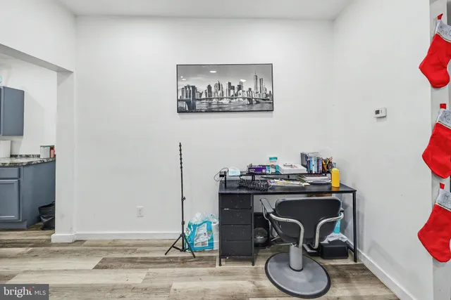 a view of a workspace with furniture and gym equipment