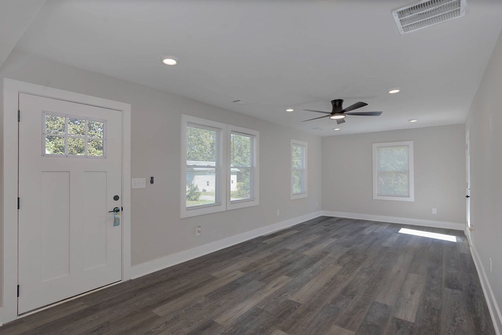 326 Mobley Street Hamilton, GA 31811 - Photo 13 of 23 wooden floor in an empty room with a window