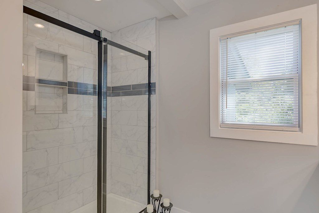 326 Mobley Street Hamilton, GA 31811 - Photo 17 of 23 a bathroom with a glass shower door