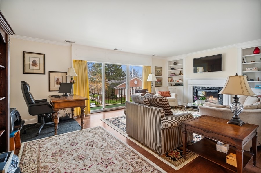 715 Ridge Road, Unit 3C Wilmette, IL 60091 - Photo 6 of 24 a living room with furniture a rug a flat screen tv and a fireplace