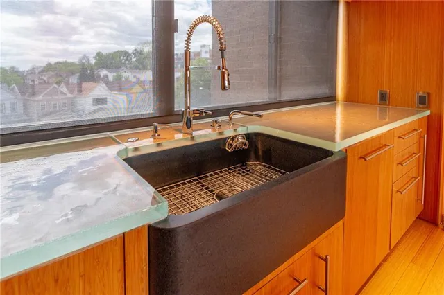 a view of a kitchen with a sink and wooden floor
