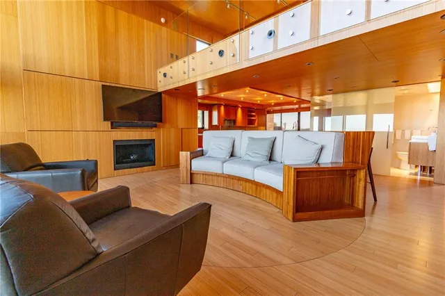 a living room with furniture and a floor to ceiling window