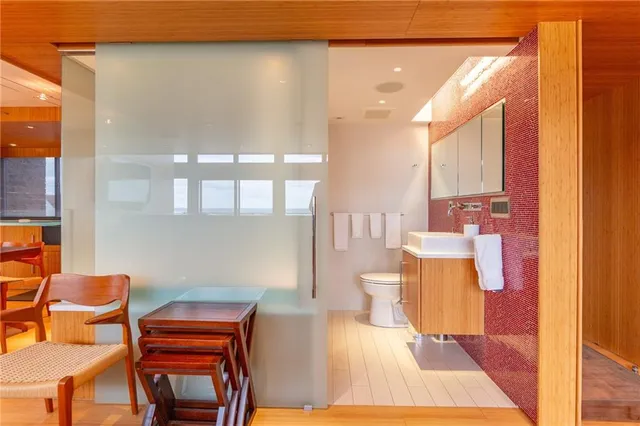 a bathroom with a tub sink and mirror