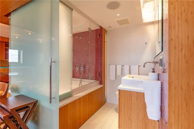 a bathroom with a sink a toilet and mirror