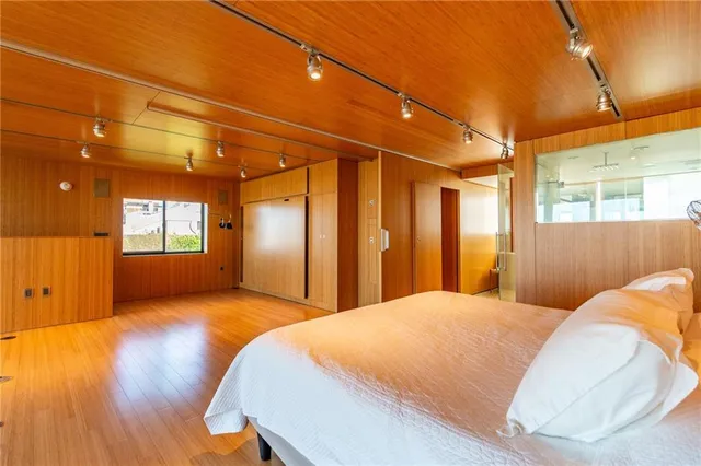 a view of a room with wooden floor and windows