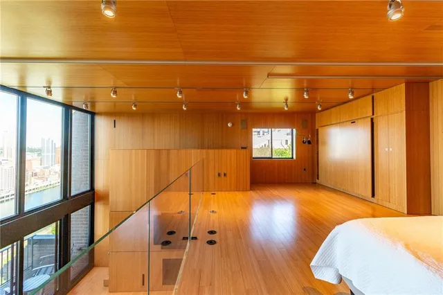 a spacious bedroom with a large window and a table