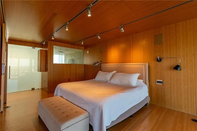 a bedroom with a bed and wooden floor