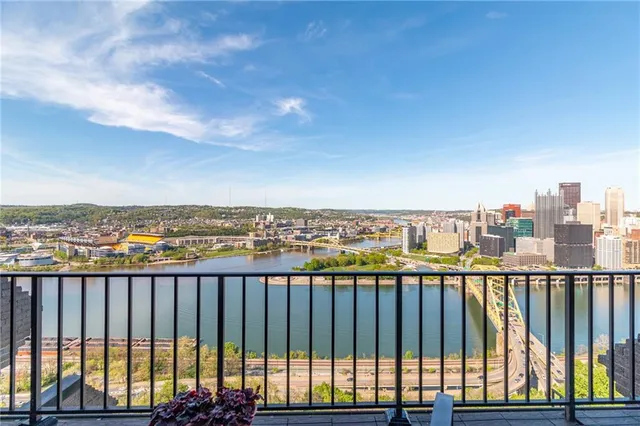 a living room with furniture a fireplace and a chandelier