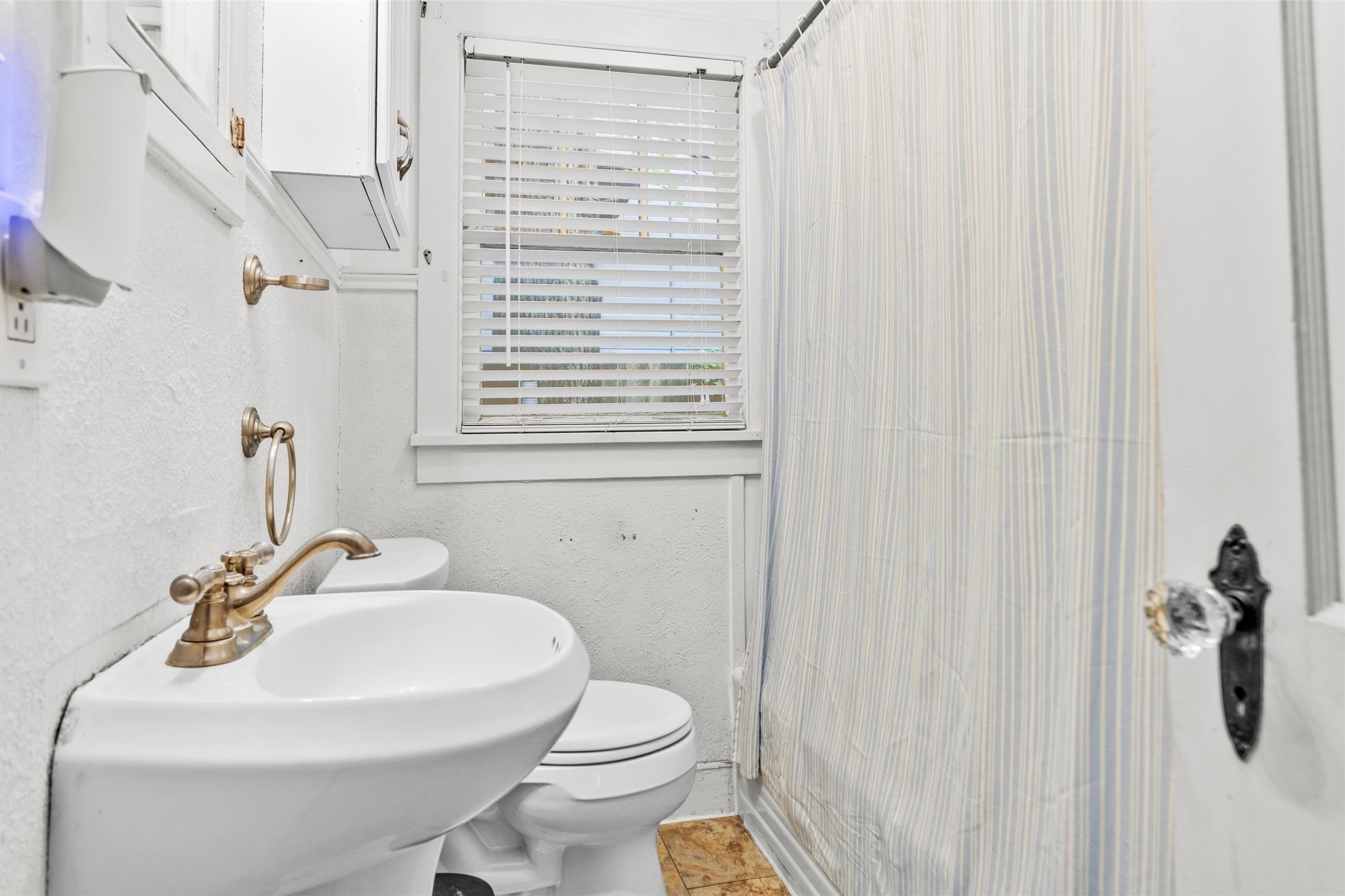 1720 18th Street Huntsville, TX 77340 - Photo 24 of 37 a bathroom with a sink a toilet and a mirror