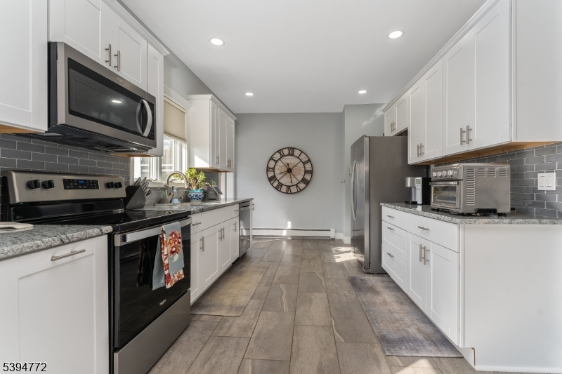 22 Fairview Avenue Clinton, NJ 08809 - Photo 11 of 31 a large kitchen with stainless steel appliances granite countertop a stove a sink and a microwave